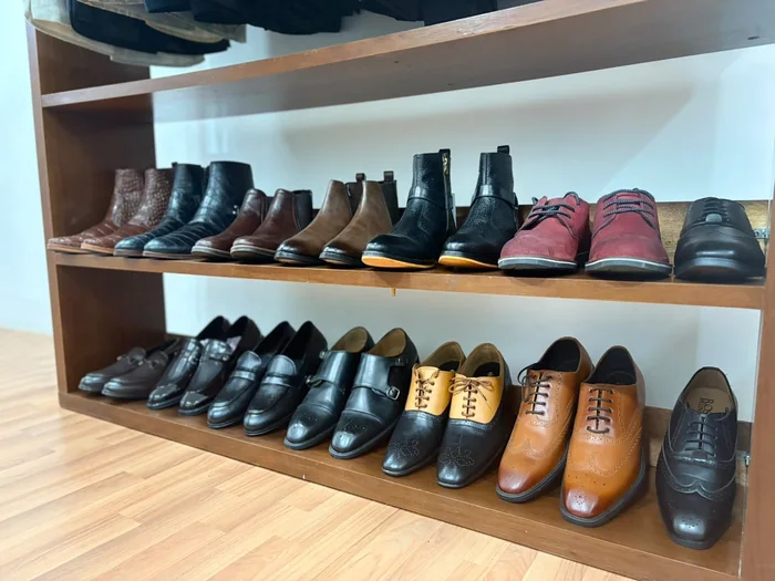 Shelves of men's formal leather shoes and boots in the Arsu store